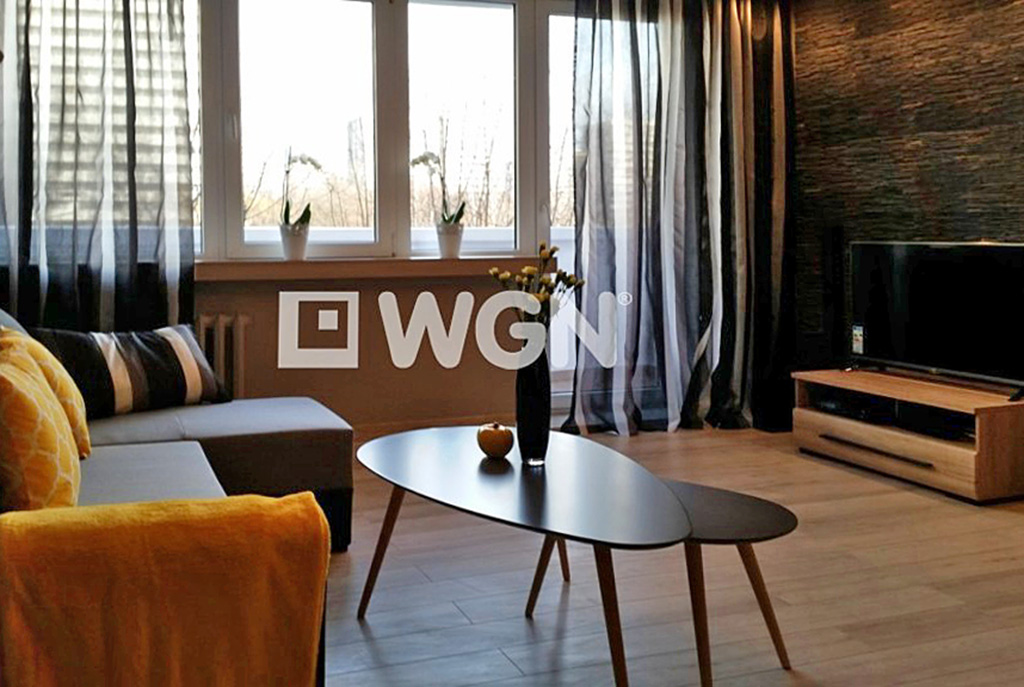 widok na salon oraz taras w luksusowym apartamencie do wynajmu w Katowicach