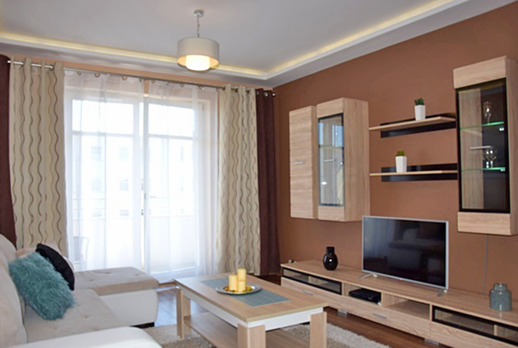 widok z innej perspektywy na luksusowy salon w ekskluzywnym apartamencie do wynajmu w Słupsku