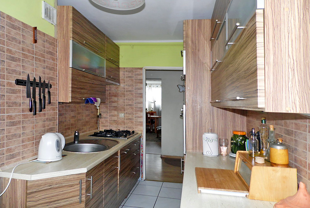 na zdjęciu umeblowana nowocześnie kuchnia w ekskluzywnym apartamencie do sprzedaży w Malborku