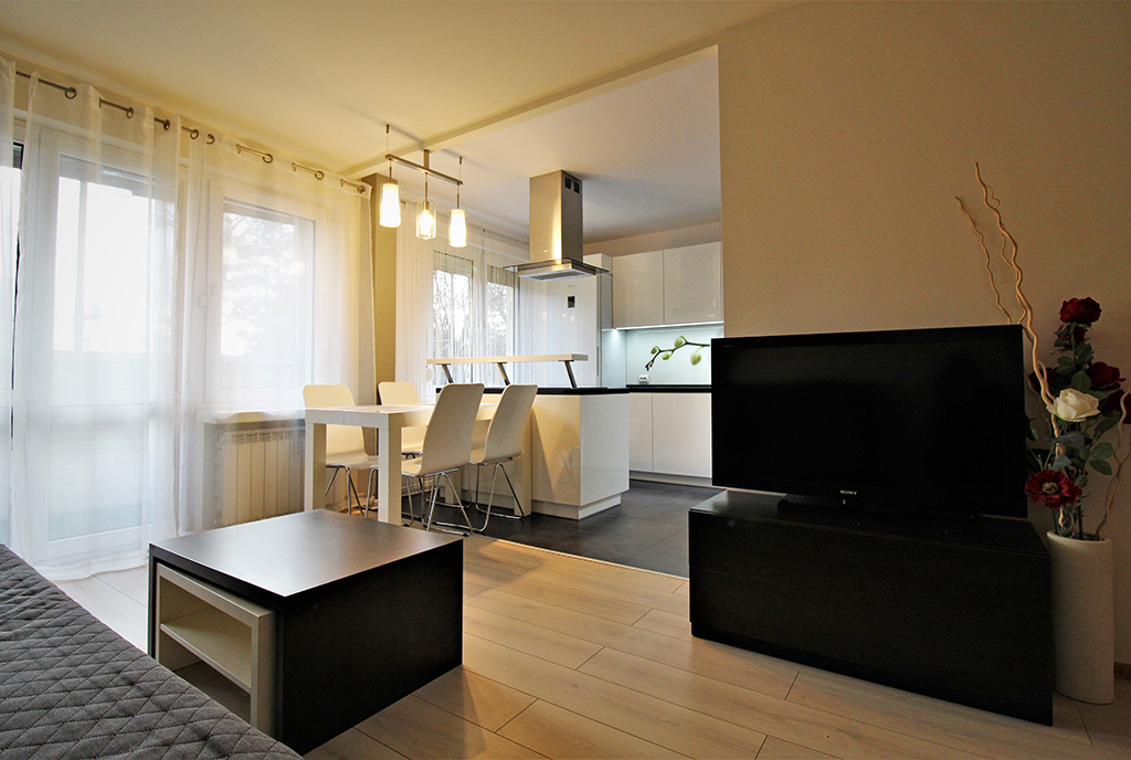 widok od strony salonu na aneks kuchenny w luksusowym apartamencie do wynajmu Kraków