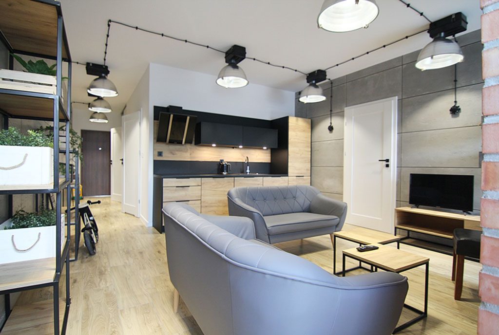 zaaranżowane w modnym trendzie wnętrze salonu w ekskluzywnym apartamencie do wynajęcia Wieluń