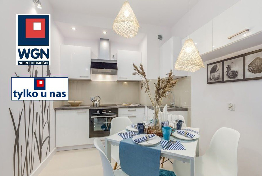 elegancka kuchnia oraz pokój dzienny w ekskluzywnym apartamencie do sprzedaży Gdańsk