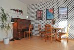 jedno z komfortowych pomieszczeń z pianinem w luksusowym apartamencie do sprzedaży Szczecin