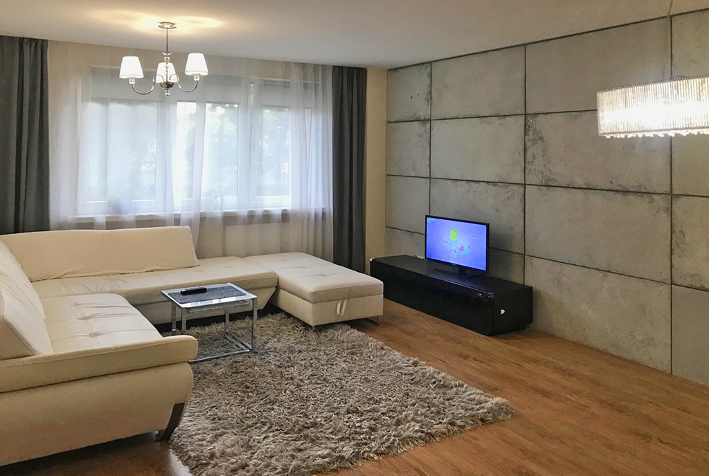 zaprojektowany zgodnie z najnowszymi trendami pokój dzienny w luksusowym apartamencie na sprzedaż Wieluń