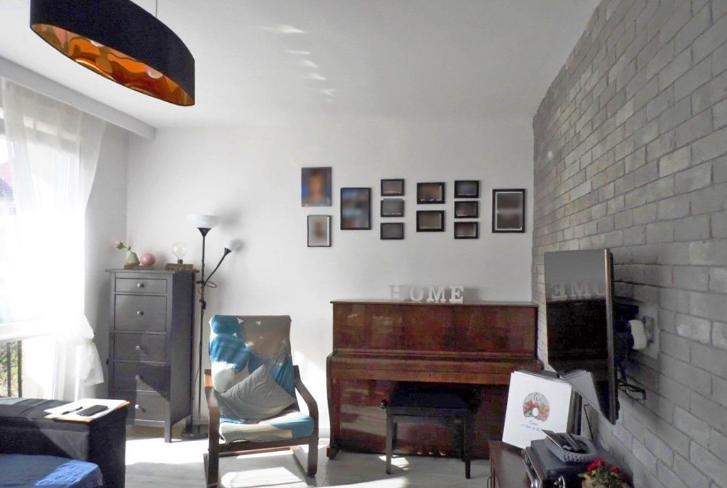 na pierwszym planie pianino w pokoju ekskluzywnego apartamentu na sprzedaż Malbork