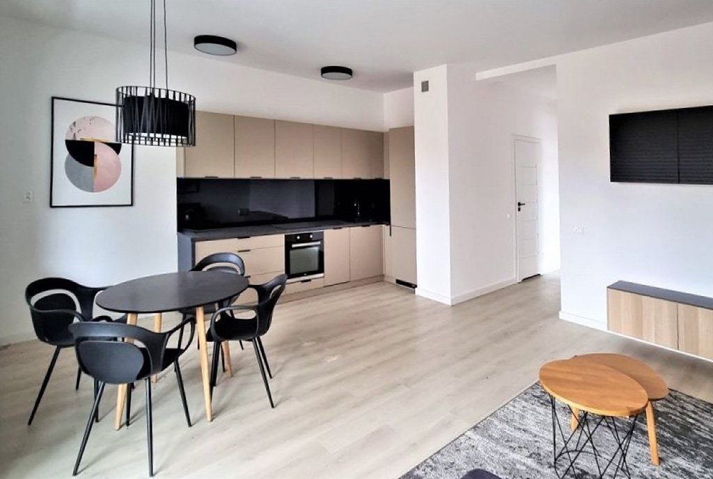 widok z salonu na aneks kuchenny w luksusowym apartamencie na sprzedaż Łódź