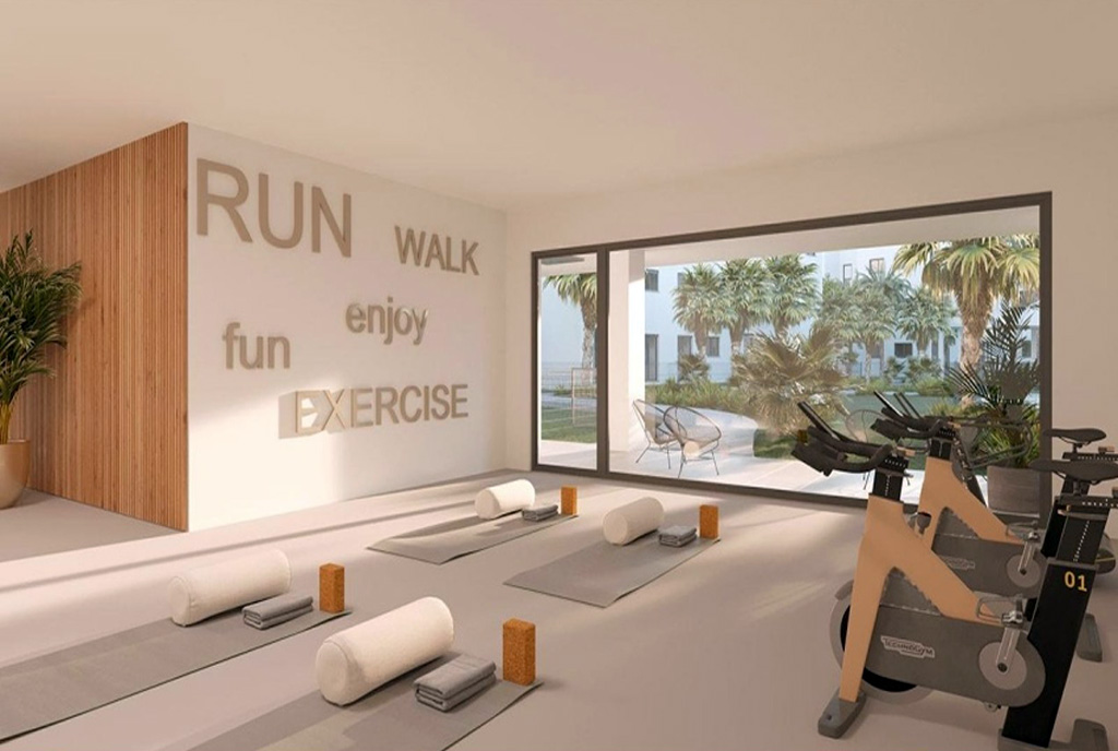 siłownia w częściach wspólnych budynku, gdzie znajduje się luksusowy apartament do sprzedaży Hiszpania (Estepona)