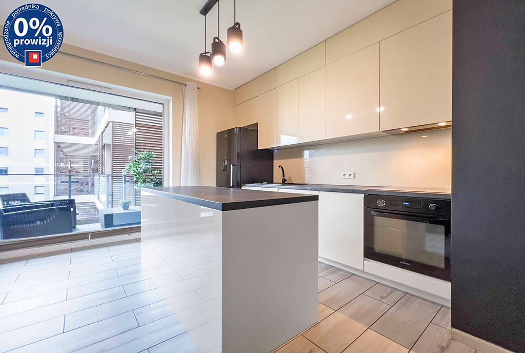 na pierwszym planie wyspa w kuchni ekskluzywnego apartamentu do sprzedaży Katowice