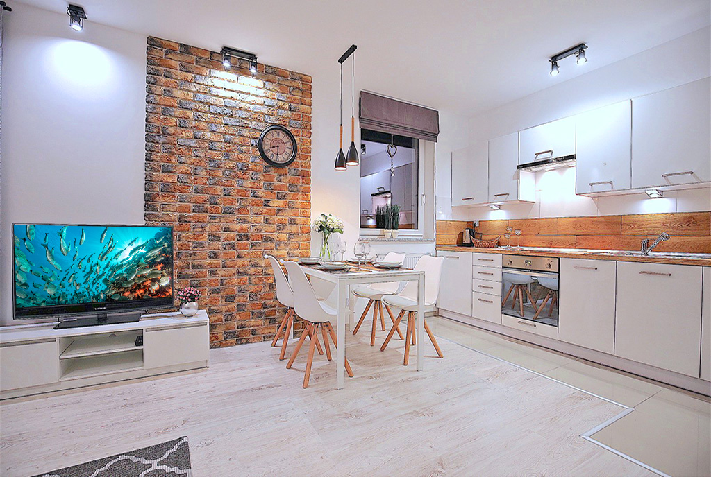 widok z salonu na aneks kuchenny i jadalnię w luksusowym apartamencie do wynajmu Szczecin