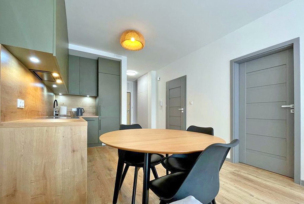 na pierwszym planie jadalnia w luksusowym apartamencie do wynajmu Piotrków Trybunalski