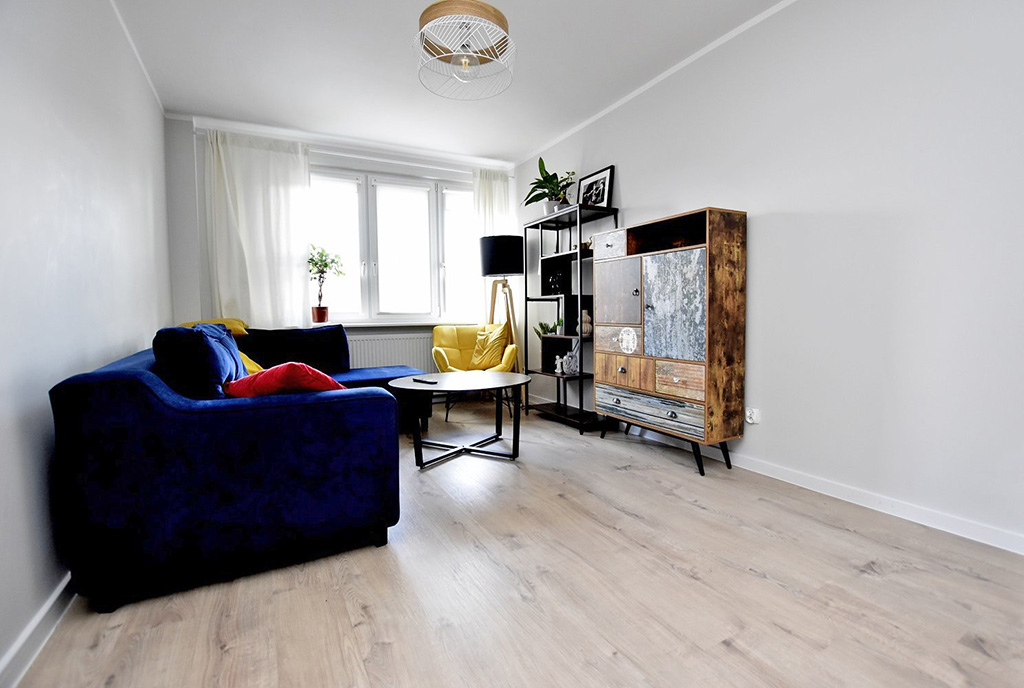 widok z aneksu kuchennego na pokój dzienny w luksusowym apartamencie na sprzedaż Inowrocław