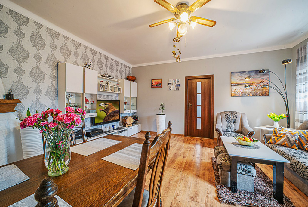 zdjęcie prezentuje jadalnię i pokój dzienny w ekskluzywnym apartamencie do sprzedaży Legnica (okolice)