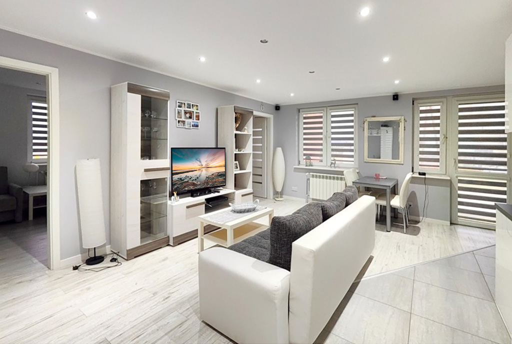 na pierwszym planie pokój gościnny w luksusowym apartamencie do sprzedaży Mazury