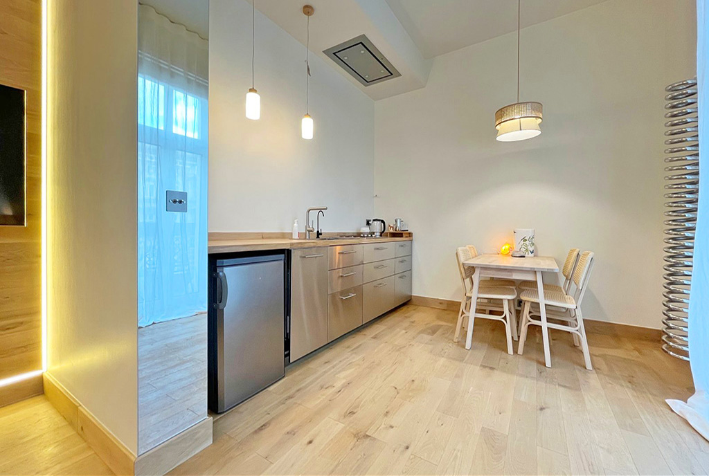 po lewej kuchnia, po prawej jadalnia w luksusowym apartamencie do wynajmu Szczecin