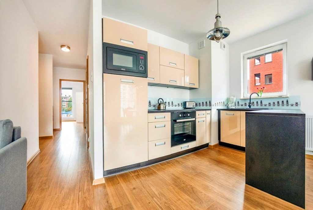 zaprojektowana w nowoczesnym stylu kuchnia w luksusowym apartamencie do wynajmu Gdańsk