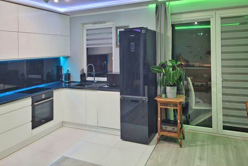 po lewej kuchnia, po prawej salon w luksusowym apartamencie na sprzedaż Gdańsk (okolice)