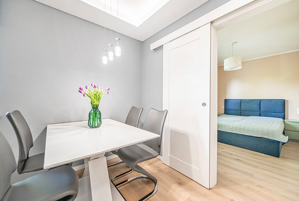 po lewej jadalnia, po prawej sypialnia w luksusowym apartamencie na sprzedaż Wrocław