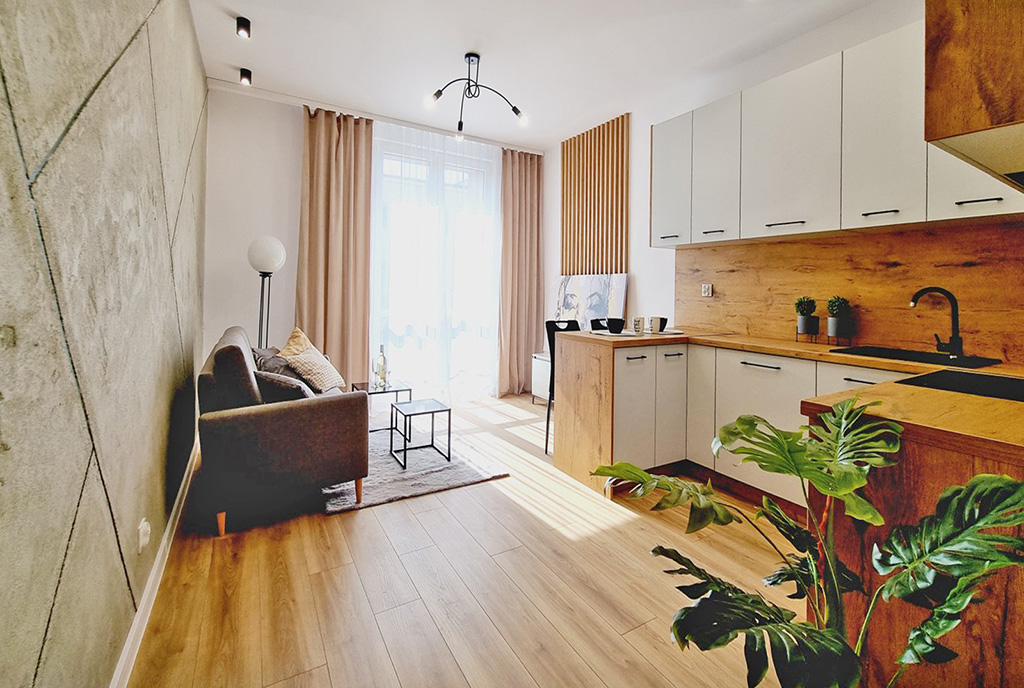 widok z kuchni na salon w luksusowym apartamencie na sprzedaż Mielec