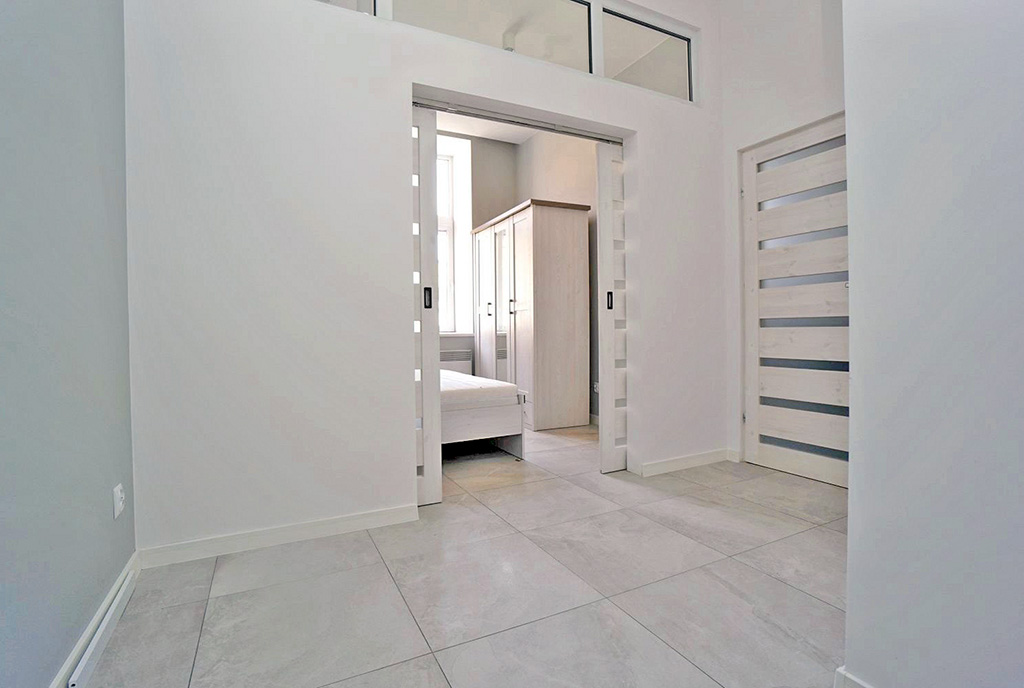 utrzymany w bieli korytarz w ekskluzywnym apartamencie na wynajem Piotrków Trybunalski