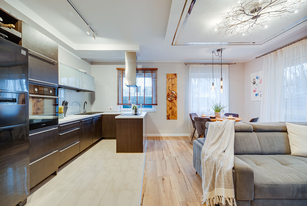 po lewej kuchnia, po prawej pokój dzienny w luksusowym apartamencie na sprzedaż Gdańsk