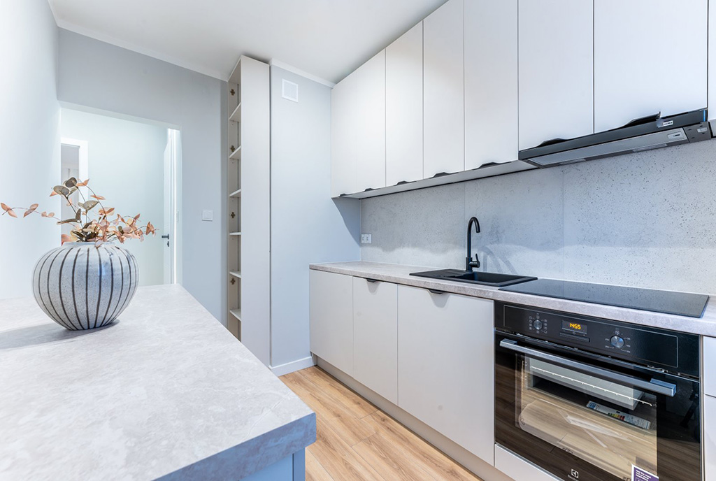 zaprojektowana w bieli i czerni kuchnia w luksusowym apartamencie na sprzedaż Gdynia okolice