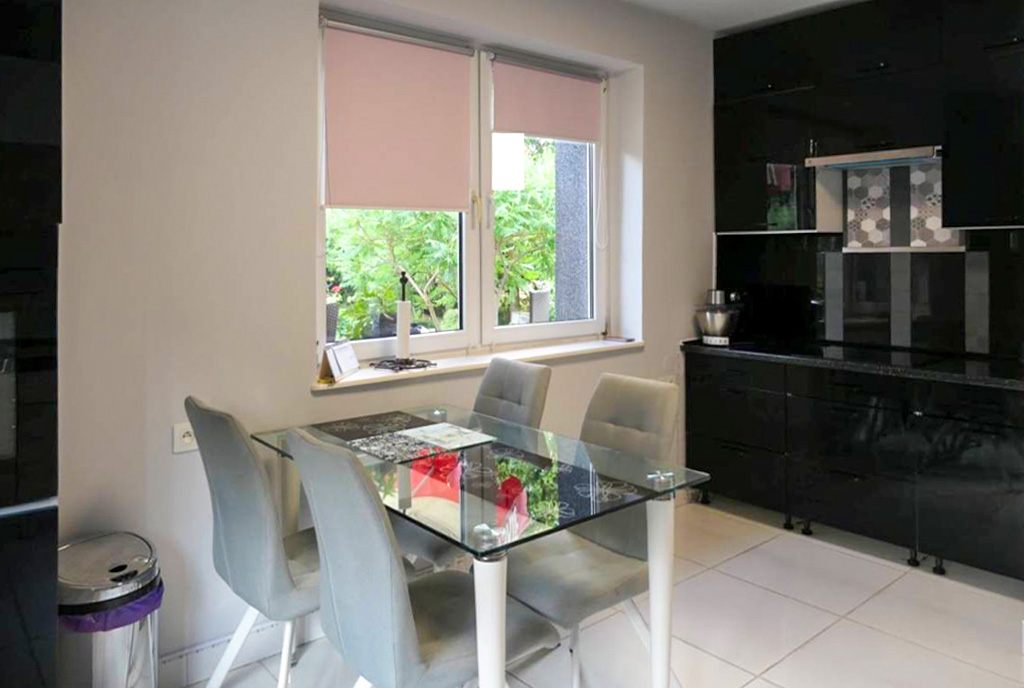 na pierwszym planie jadalnia, w oddali kuchnia w luksusowej willi na sprzedaż Kwidzyn