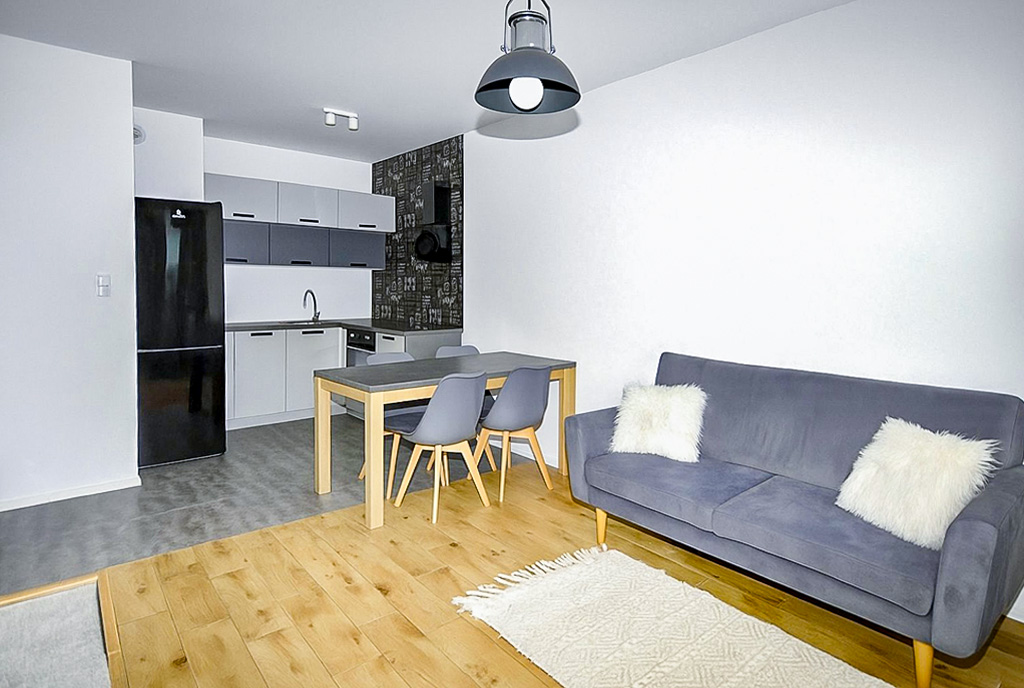 widok z salonu na aneks kuchenny w ekskluzywnym apartamencie do wynajęcia Gdynia okolice