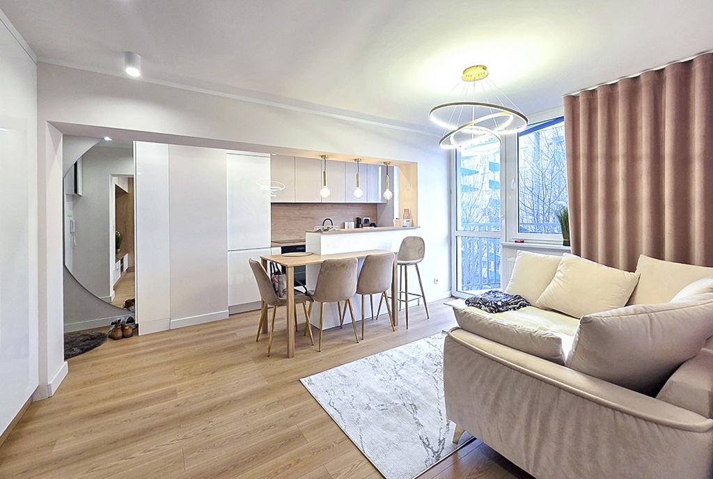 na pierwszym planie salon, w oddali kuchnia w luksusowym apartamencie na sprzedaż Apartament do sprzedaży Katowice