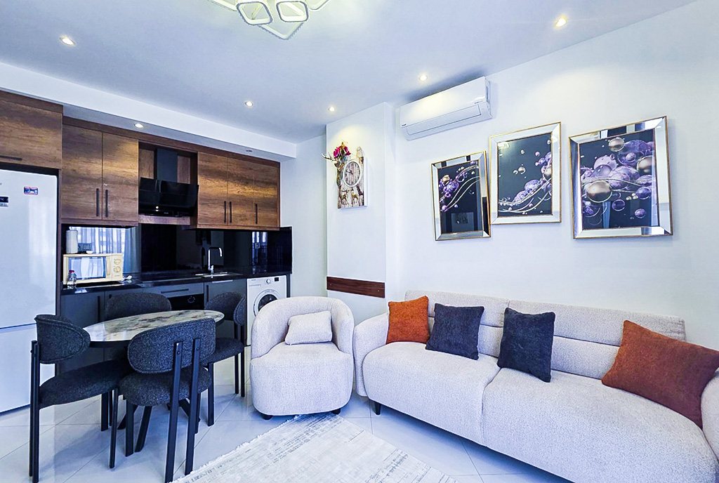 po lewej kuchnia, po prawej salon w luksusowym apartamencie na sprzedaż Turcja Alanya