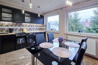 na zdjęciu jadalnia, w oddali kuchnia w luksusowym apartamencie do wynajmu Bielsko-Biała okolice