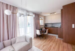 Widok salonu na kuchnię w luksusowym apartamencie na sprzedaż Mielec.