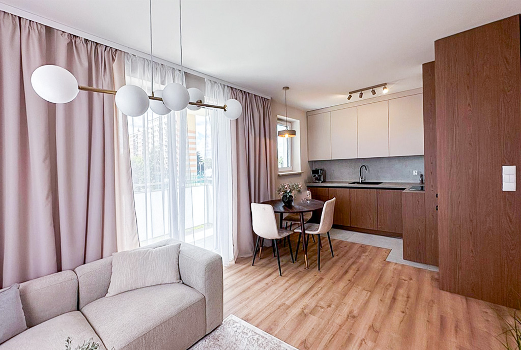 Widok salonu na kuchnię w luksusowym apartamencie na sprzedaż Mielec.
